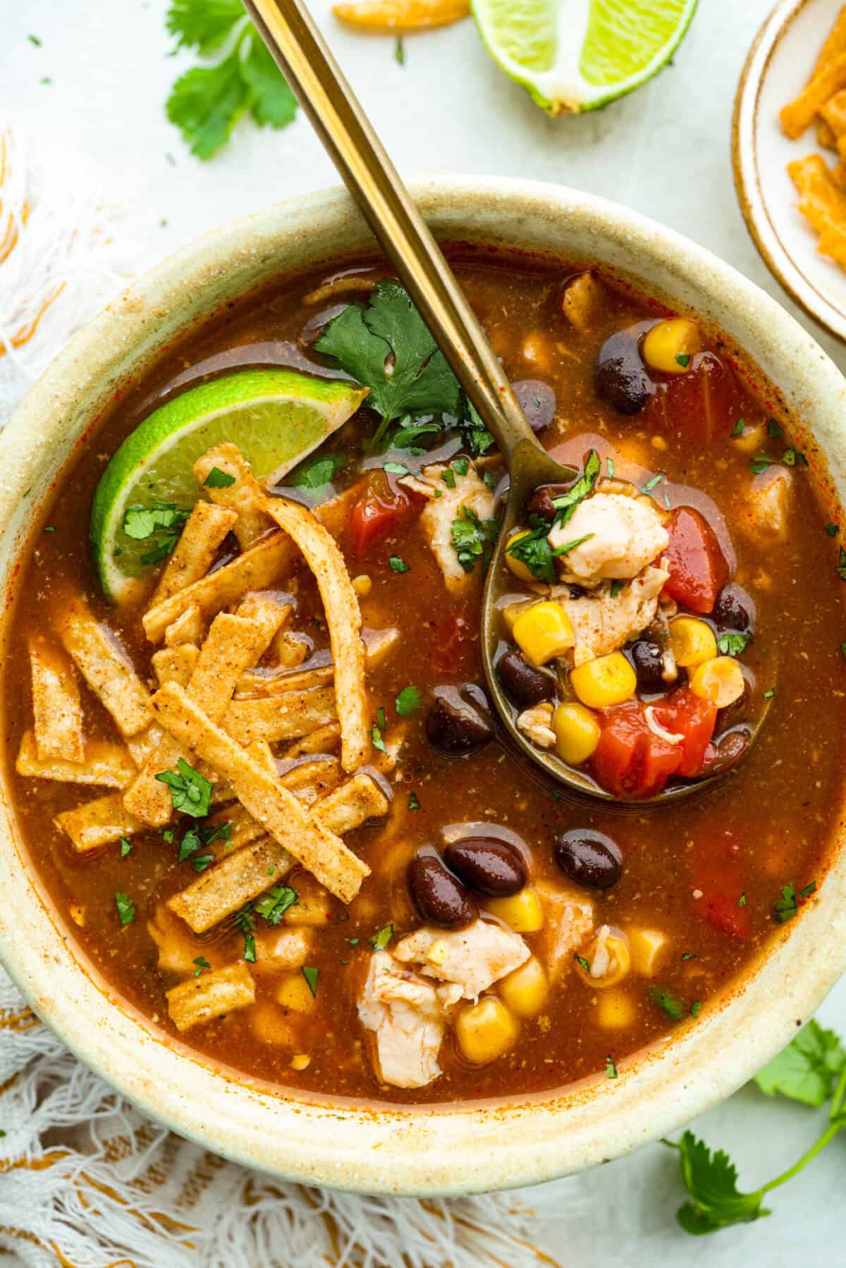 It doesn't get any easier than this 8 Can Chicken Tortilla Soup! Dinner is ready in minutes! Just open, dump, heat, and enjoy bold, delicious flavor in no time! Bowl of 8 can chicken tortilla soup.