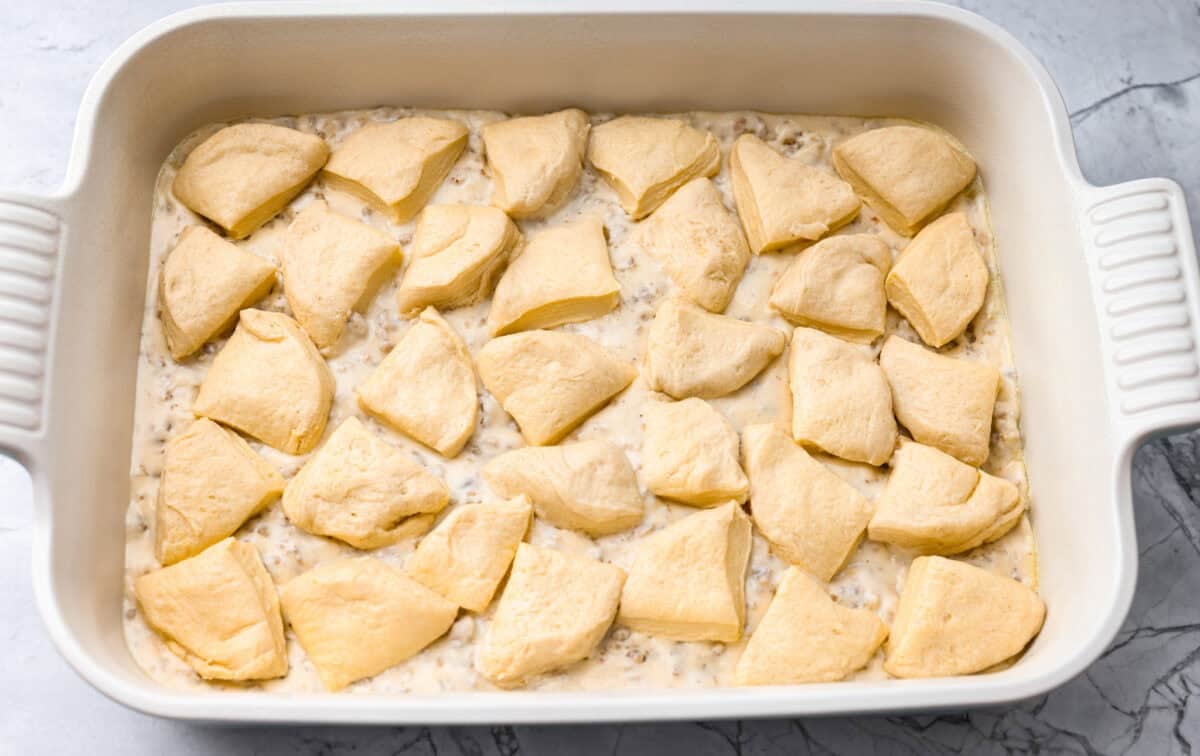 Pieces of the cut up biscuits on top of the sausage gravy.