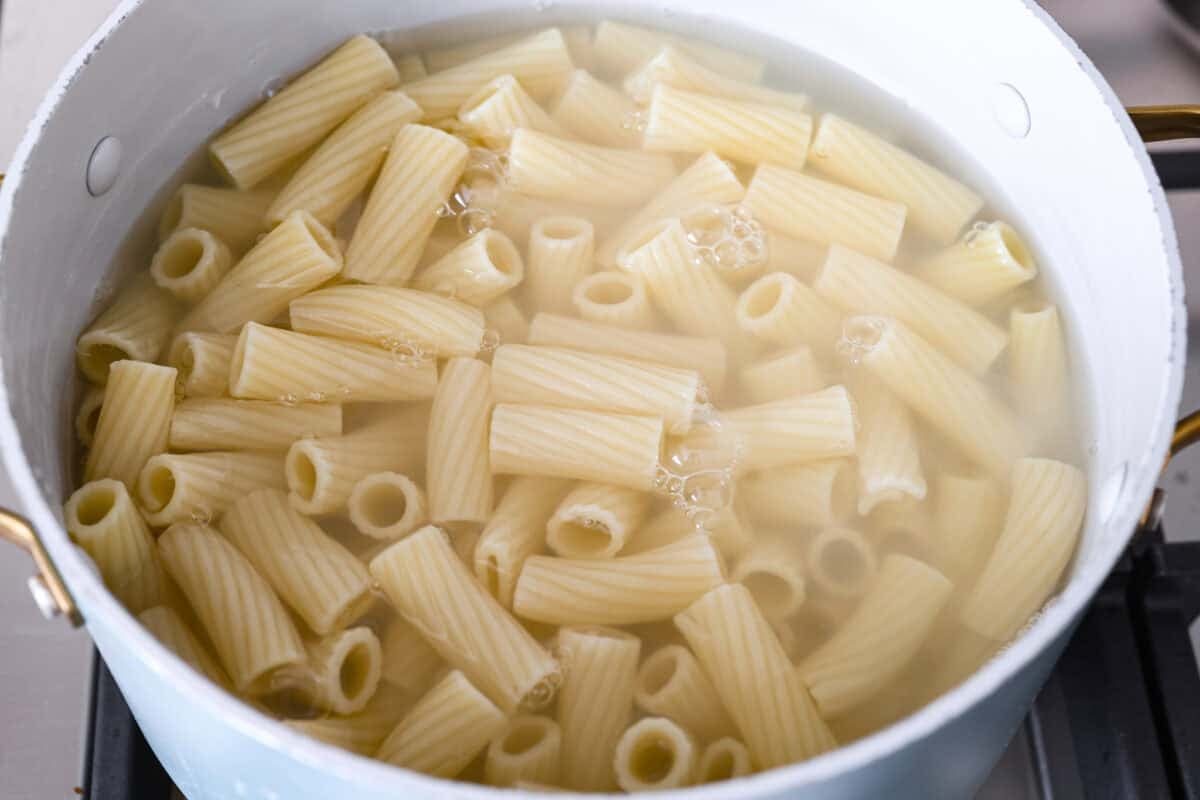 Pasta cooking in boiling water in a pot.