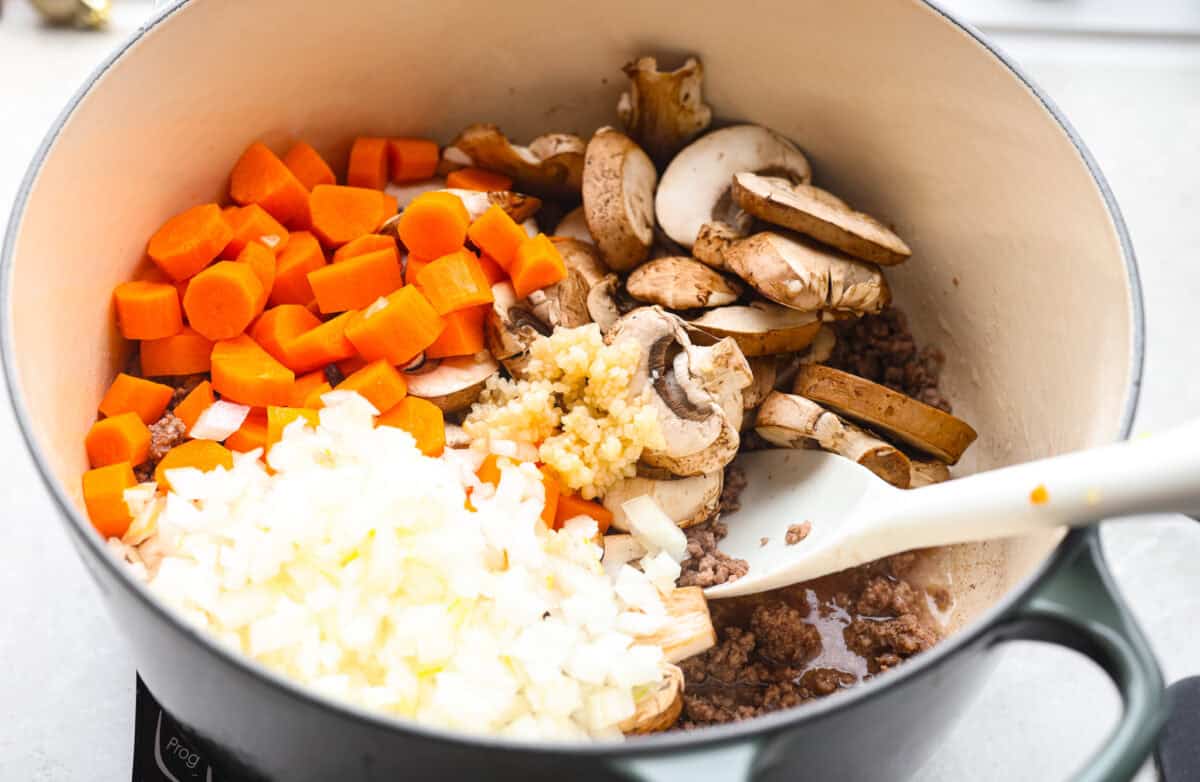 If groceries feel higher than ever, you’re not alone. That’s why I love hobo stew. It's cozy, hearty, and made from whatever’s in the pantry. It turns simple ingredients into a meal everyone will love. Carrots, mushrooms, onion and garlic added to the cooked ground beef.