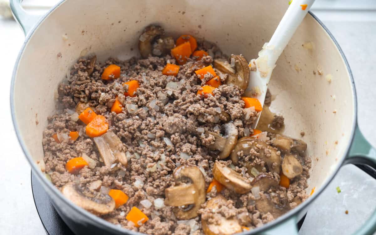 If groceries feel higher than ever, you’re not alone. That’s why I love hobo stew. It's cozy, hearty, and made from whatever’s in the pantry. It turns simple ingredients into a meal everyone will love. Cooked veggies and beef in the dutch oven.