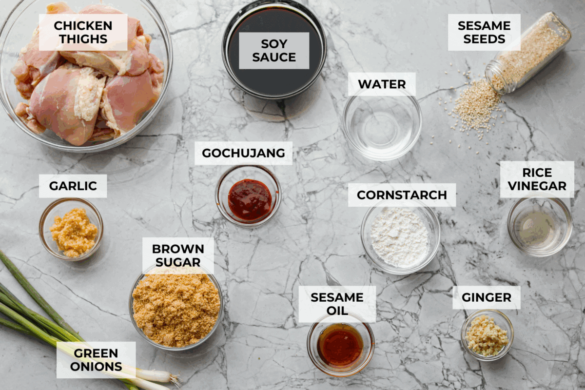 Set it and forget it! This slow cooker Korean BBQ chicken is sweet, savory, and just the right amount of spice. Perfect for tossing over rice, piling onto buns, topping a salad, or even making tacos. Weeknight dinner just got easier! Overhead shot of labeled ingredients.