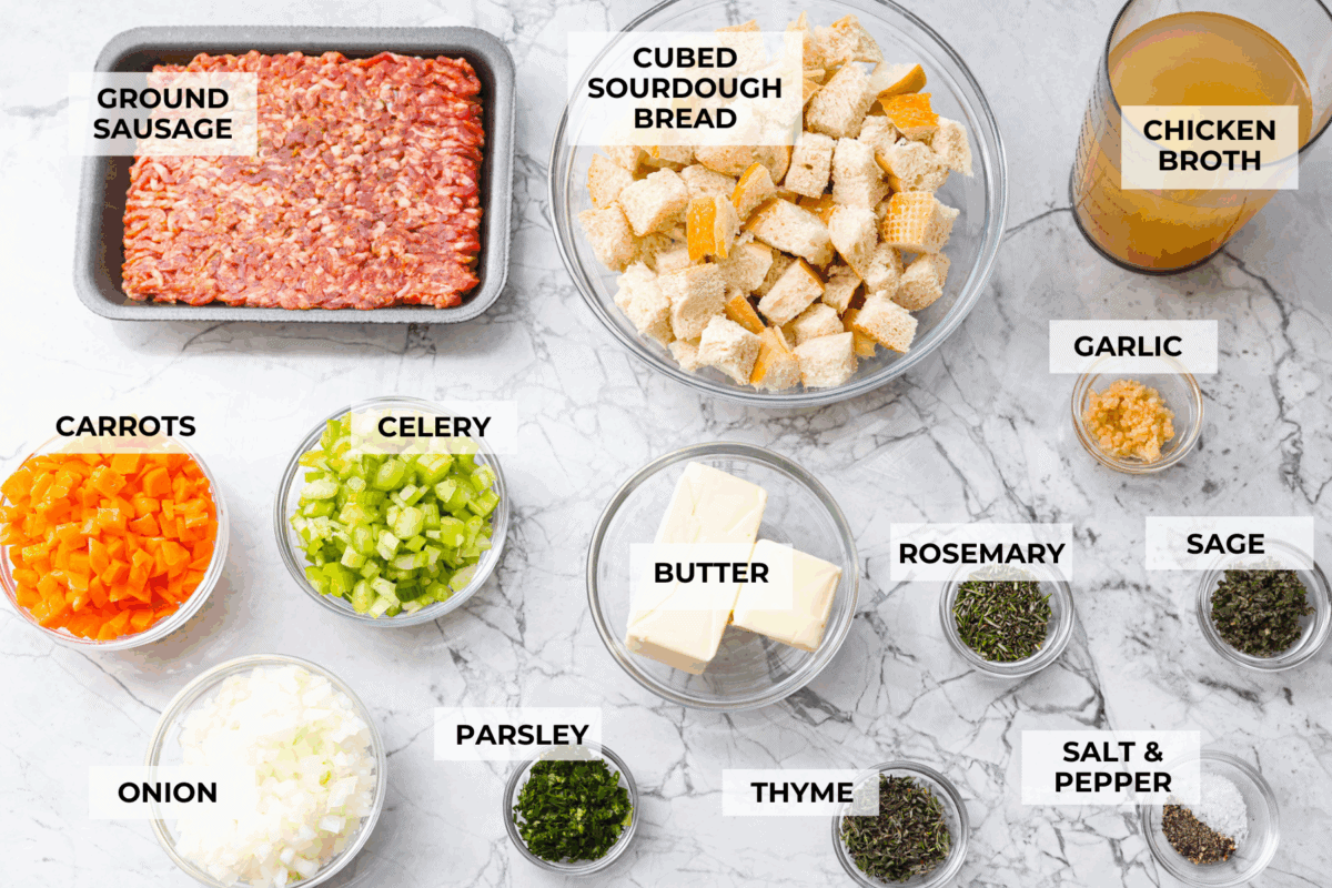 Why did it take me this long to use it in stuffing? Sourdough Stuffing's tangy crust and the chewy middle are perfection! Every bite soaks up all that buttery, herby goodness like it was made for this. Overhead shot of labeled ingredients.