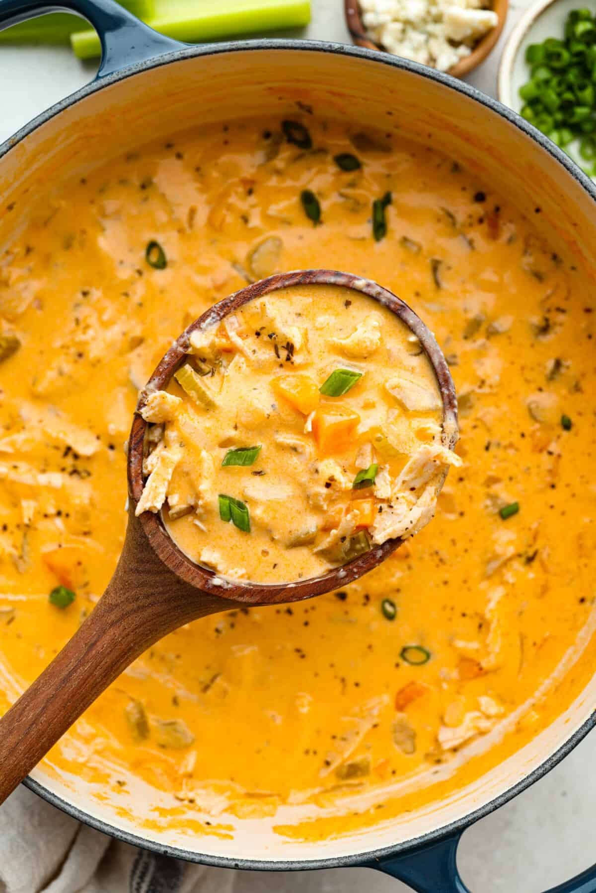 This buffalo chicken soup is about to be your new favorite! It’s creamy, spicy, and loaded with tender chicken and bold flavor, all ready in just 30 minutes. Perfect for busy weeknights, game day, or when you need a cozy meal with a little kick. Close up shot of a scoop of the buffalo chicken soup.