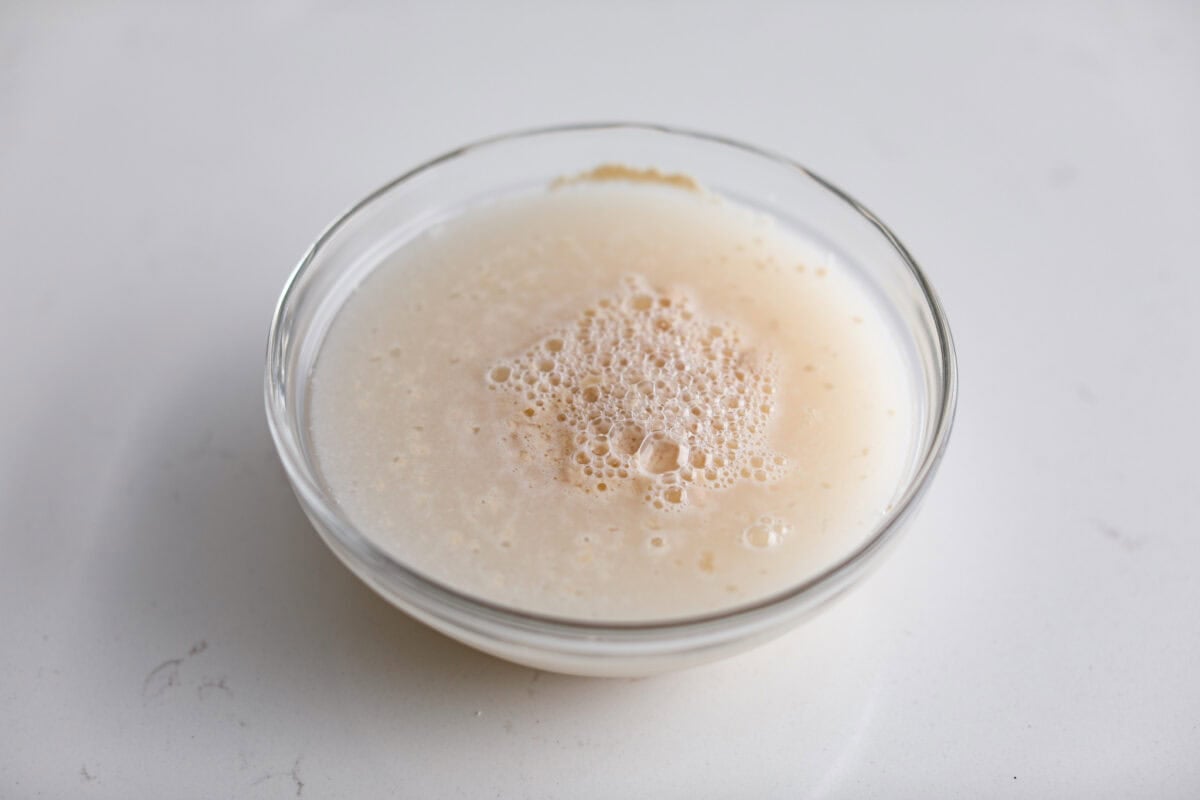 Yeast, warm water, and sugar in a bowl. 