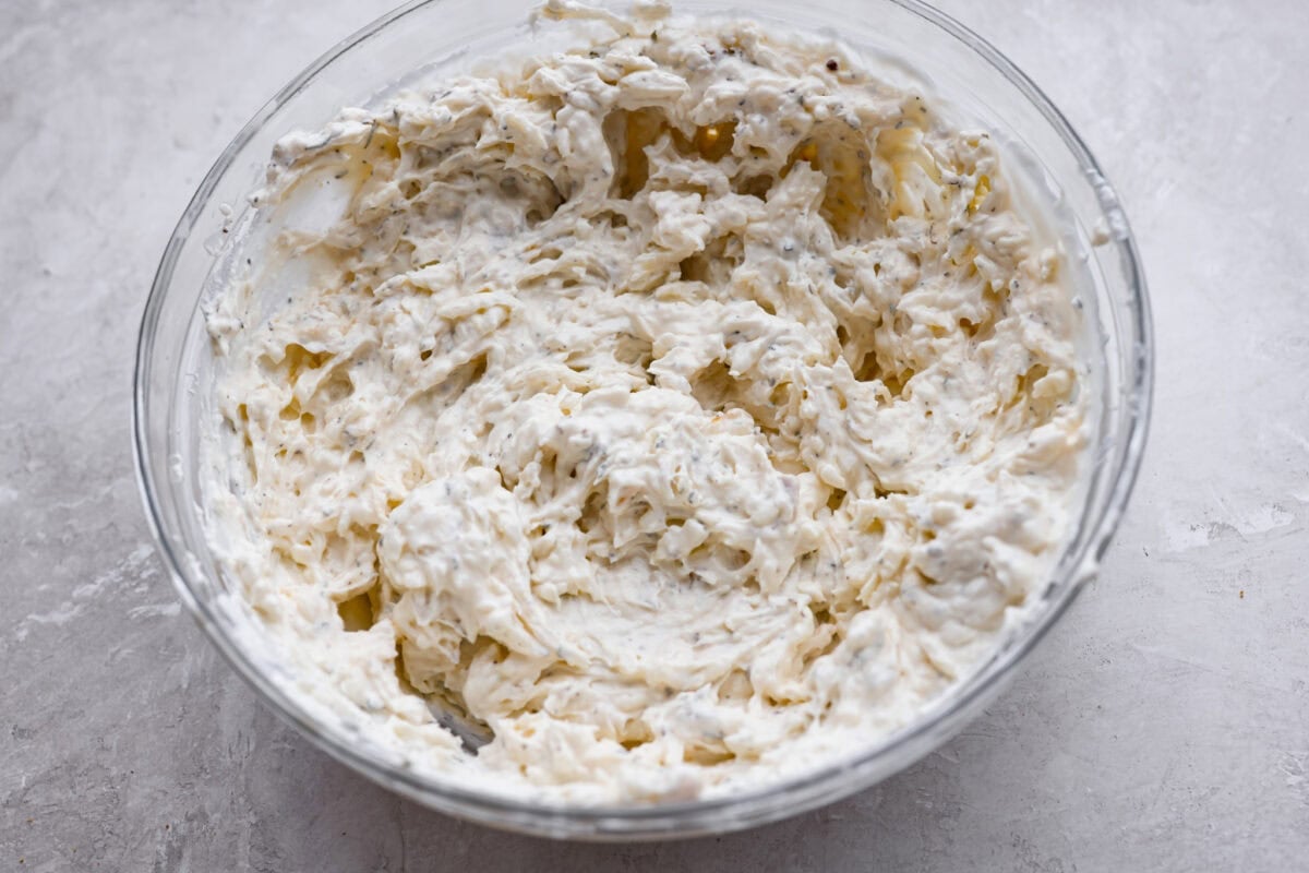 Cheesy garlic bread made into the dip of your dreams! This Garlic Bread Dip is full of roasted garlic and layers of melty cheese. It's irresistible from the very first bite! All of the garlic bread dip ingredients mixed together.