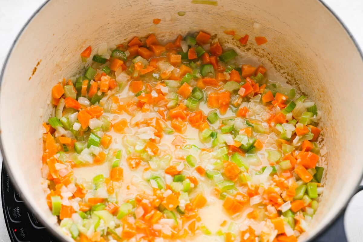 Why did it take me this long to use it in stuffing? Sourdough Stuffing's tangy crust and the chewy middle are perfection! Every bite soaks up all that buttery, herby goodness like it was made for this. Veggies and butter cooking in a pot.