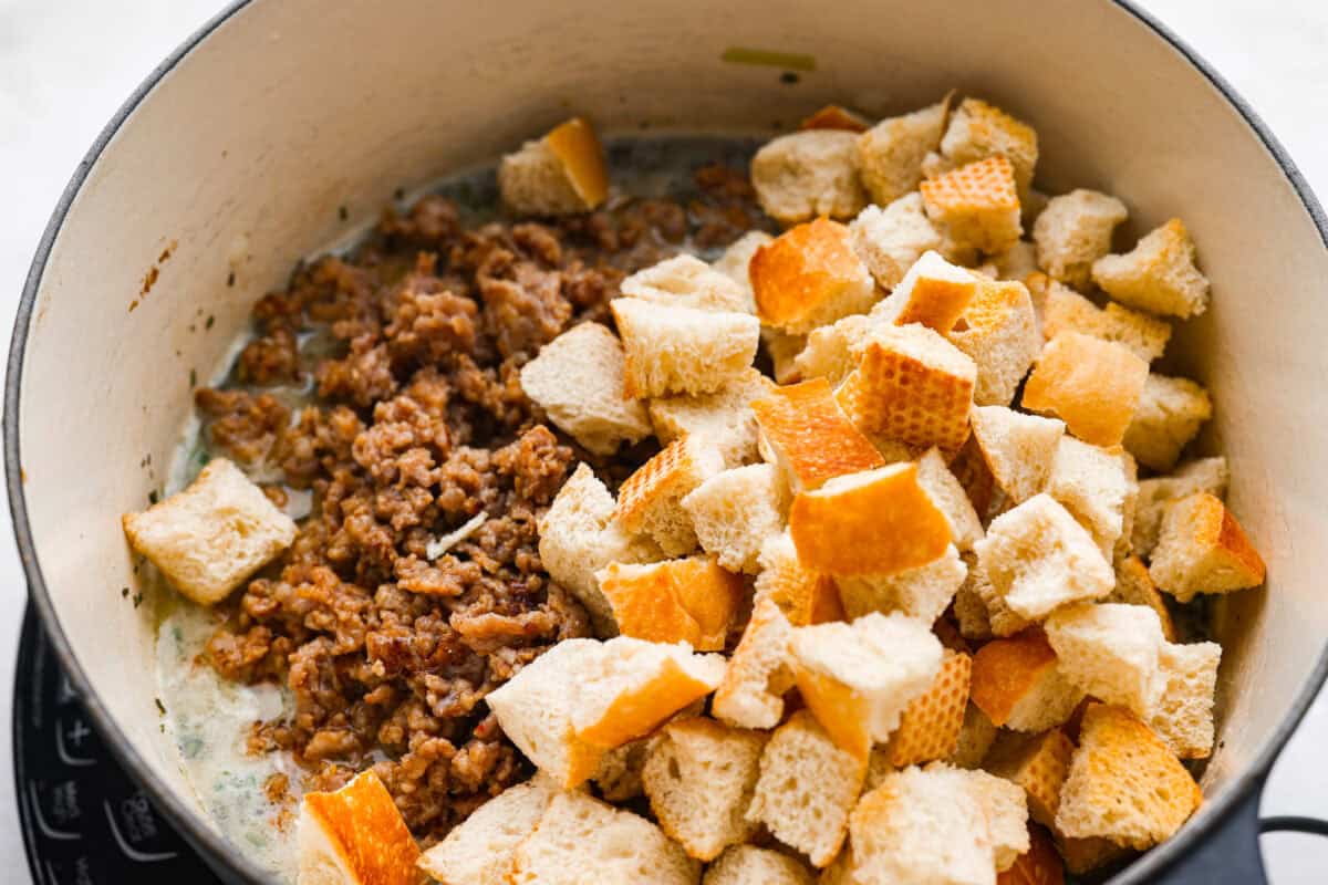 Why did it take me this long to use it in stuffing? Sourdough Stuffing's tangy crust and the chewy middle are perfection! Every bite soaks up all that buttery, herby goodness like it was made for this. Sausage and bread added to the broth and herb mixture.