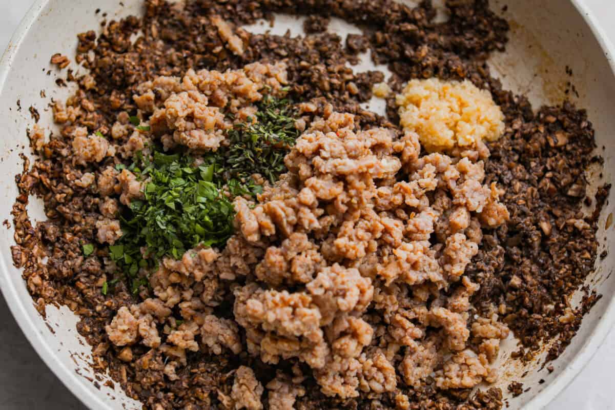 Trust me, this Stuffed Mushroom Dip is way easier (and honestly better) than making stuffed mushrooms. You skip all the filling and baking but still get that creamy, cheesy, herby, sausage flavor everyone’s obsessed with. Sausage and seasonings added to the cooked mushrooms.