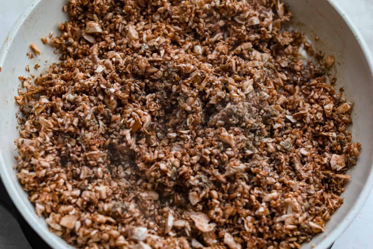 Trust me, this Stuffed Mushroom Dip is way easier (and honestly better) than making stuffed mushrooms. You skip all the filling and baking but still get that creamy, cheesy, herby, sausage flavor everyone’s obsessed with. Mushrooms and. butter cooking in a skillet.