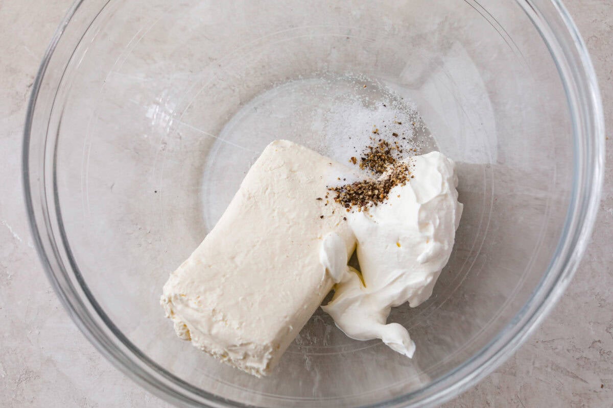 Trust me, this Stuffed Mushroom Dip is way easier (and honestly better) than making stuffed mushrooms. You skip all the filling and baking but still get that creamy, cheesy, herby, sausage flavor everyone’s obsessed with. Sour cream and cream cheese added to a mixing bowl.