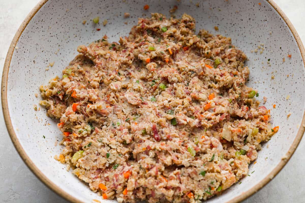 I'm telling you guys right now, sausage stuffing balls are the best part of my holiday table. They're crispy on the outside, soft and savory on the inside, and loaded with classic stuffing flavor. Easy to make, fun to share, and they disappear fast. All of the ingredients mixed together in a mixing bowl.