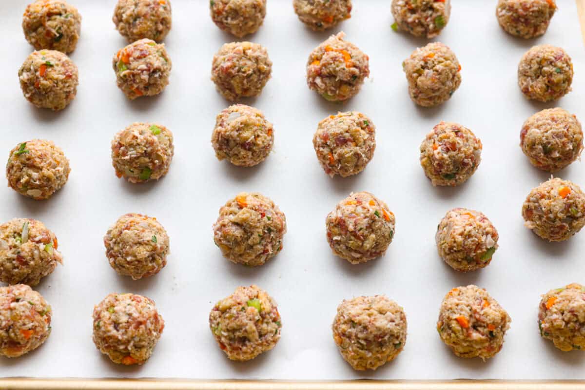 I'm telling you guys right now, sausage stuffing balls are the best part of my holiday table. They're crispy on the outside, soft and savory on the inside, and loaded with classic stuffing flavor. Easy to make, fun to share, and they disappear fast. Stuffing balls ready to be baked on a baking sheet.