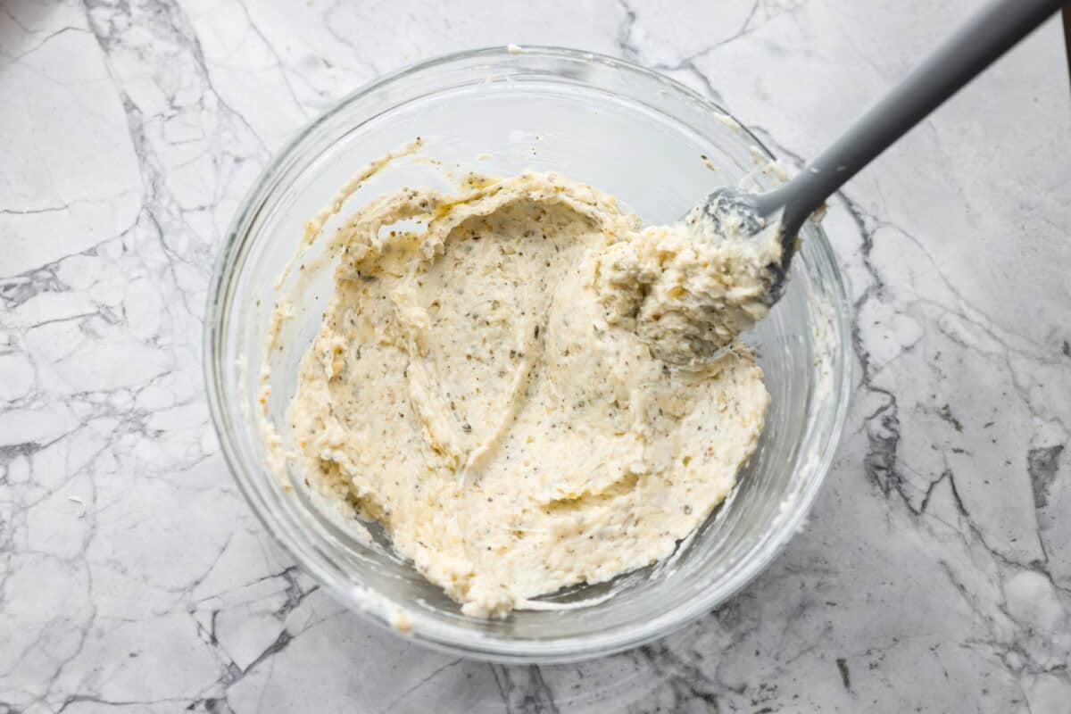 You all loved my best homemade garlic bread so much that an air fryer version was a must! It’s got the same buttery, garlicky magic, just quicker, crispier, and even easier. Garlic butter mixture in a small glass bowl.