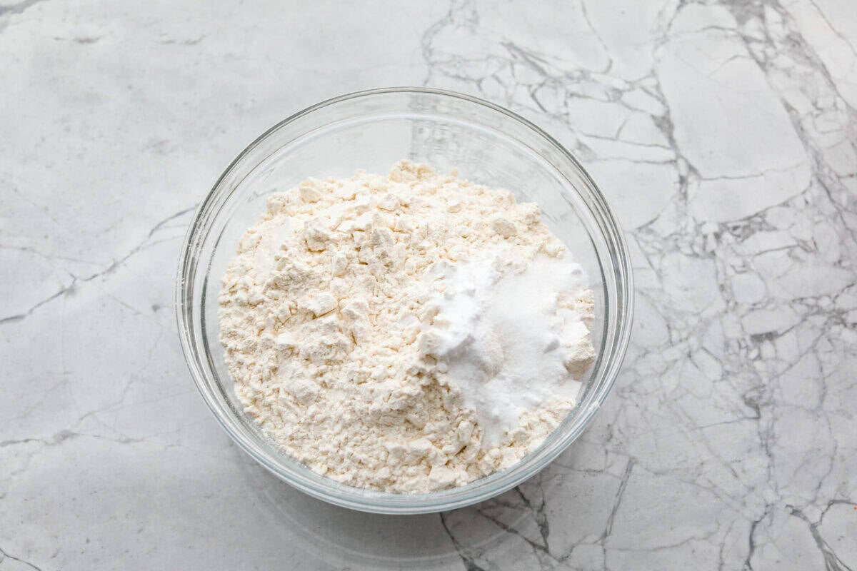 Dry ingredients added to a mixing bowl. 