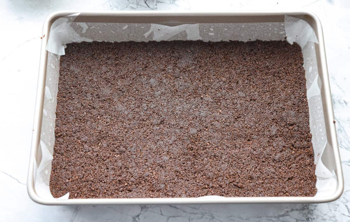 Crust ingredients smashed into the bottom of a pan. 