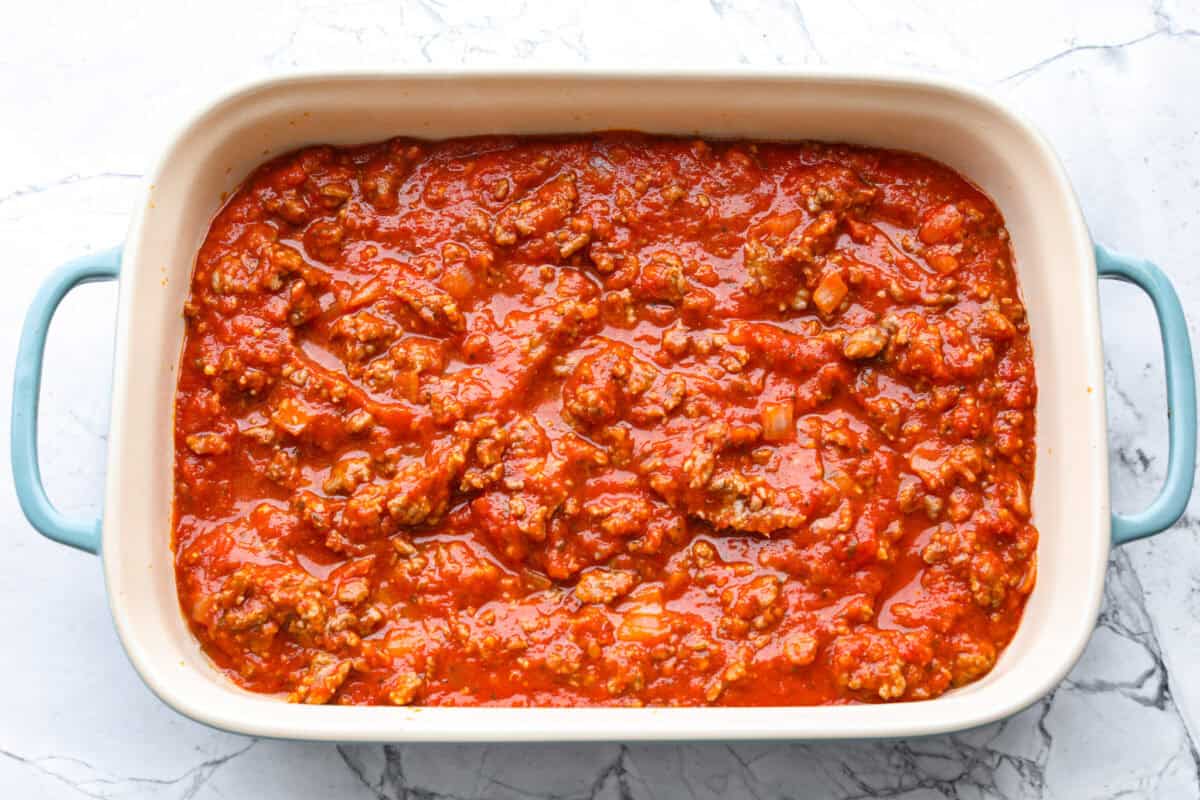 https://www.target.com/p/rao-39-s-homemade-marinara-sauce-premium-quality-all-natural-tomato-sauce-38-pasta-sauce-keto-friendly-38-carb-conscious-24oz/-/A-13349580#lnk=sametab Marinara meat mixture added to the bottom of the baking dish.