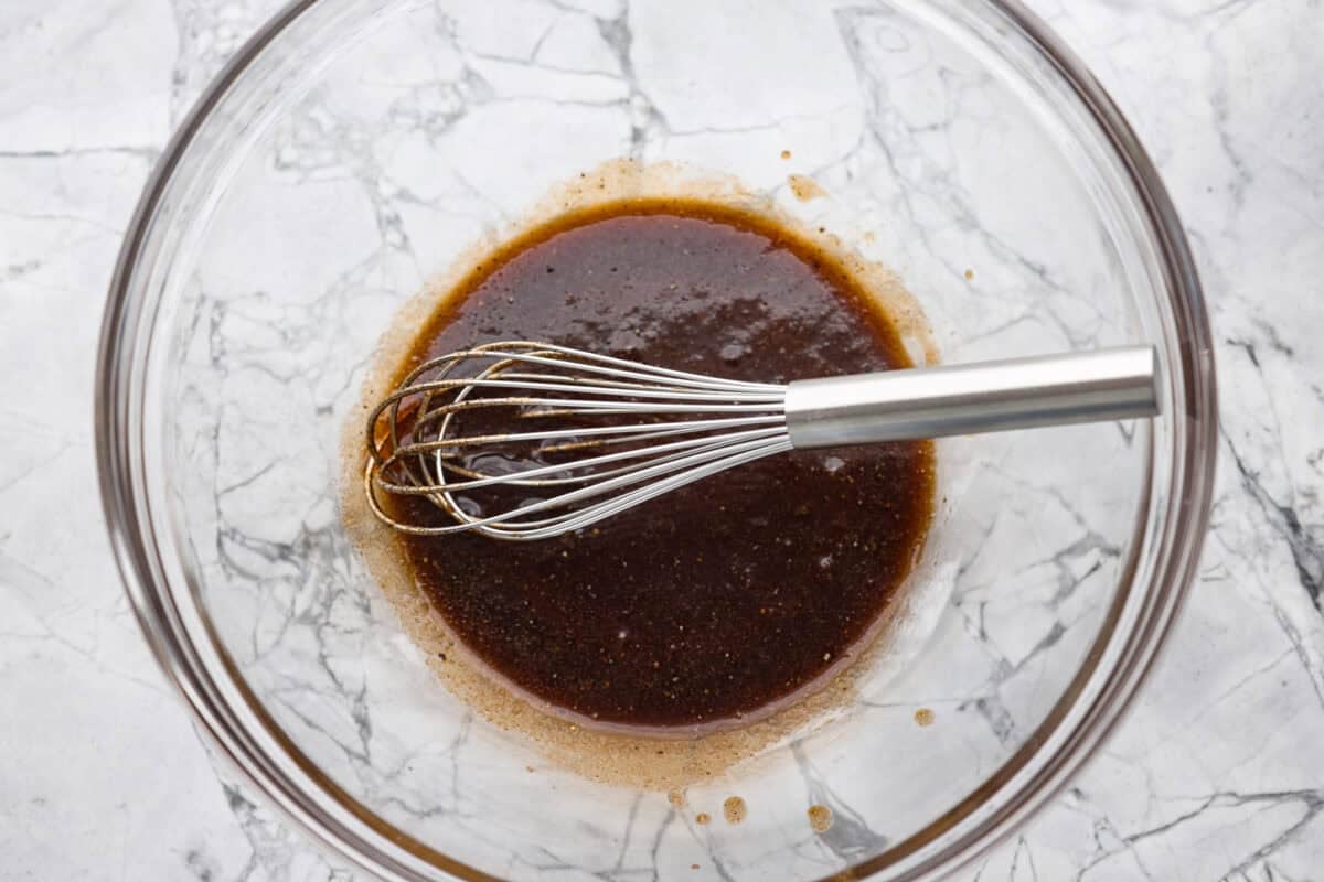 If you don’t normally love Brussels sprouts, this version might surprise you. The air fryer makes these brown sugar Brussels sprouts crisp, done in minutes, and the brown sugar caramelizes them perfectly! Bowl of sauce ingredients whisked together.