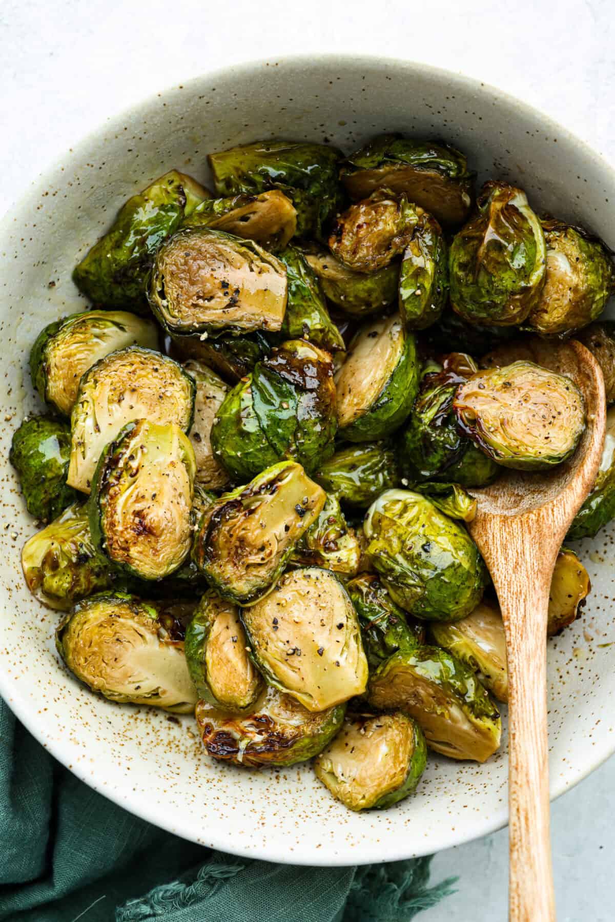 If you don’t normally love Brussels sprouts, this version might surprise you. The air fryer makes these brown sugar Brussels sprouts crisp, done in minutes, and the brown sugar caramelizes them perfectly! Bowl of air fryer brown sugar Brussels sprouts.