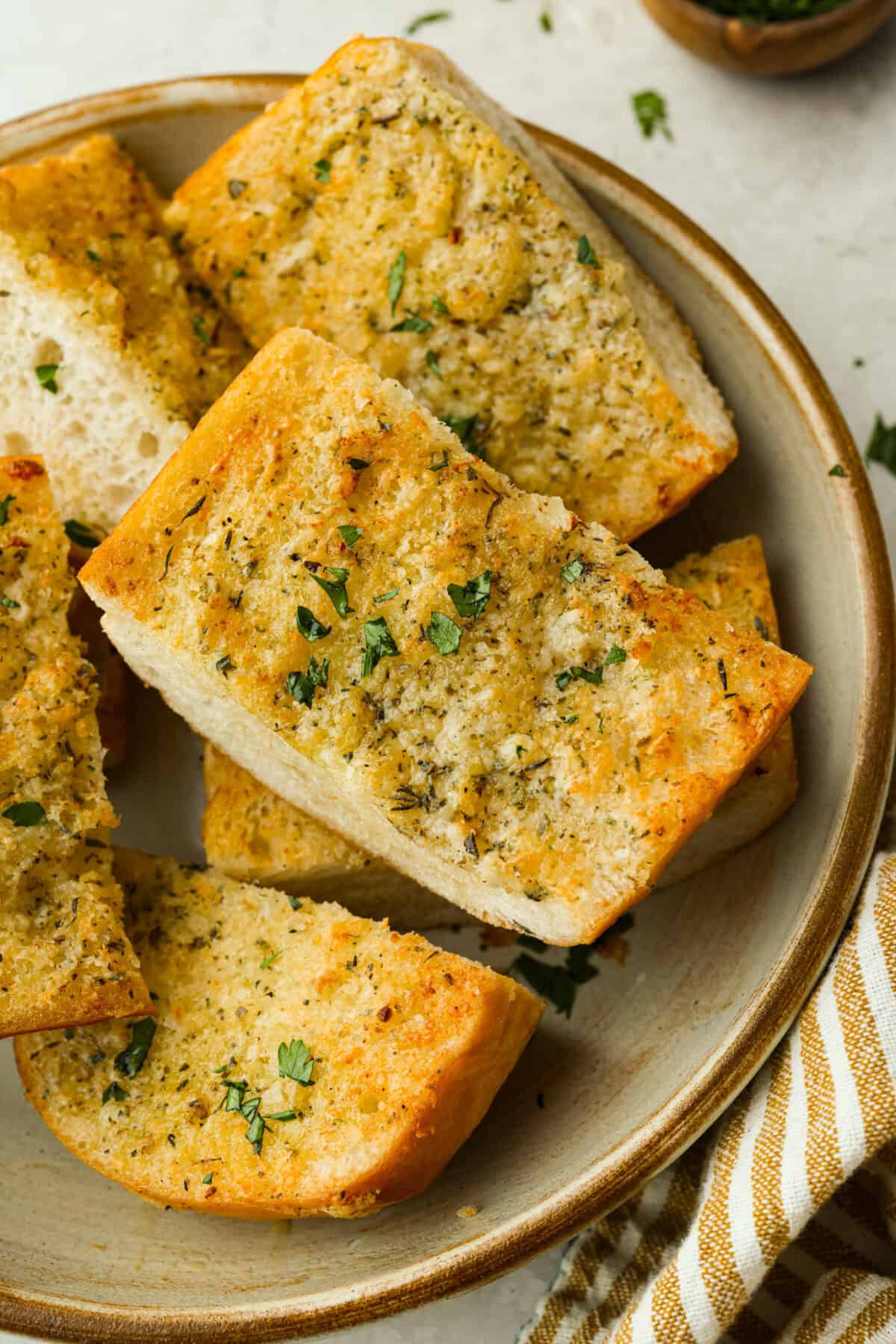 You all loved my best homemade garlic bread so much that an air fryer version was a must! It’s got the same buttery, garlicky magic, just quicker, crispier, and even easier. Plate of air fryer garlic bread cut into serving sizes.