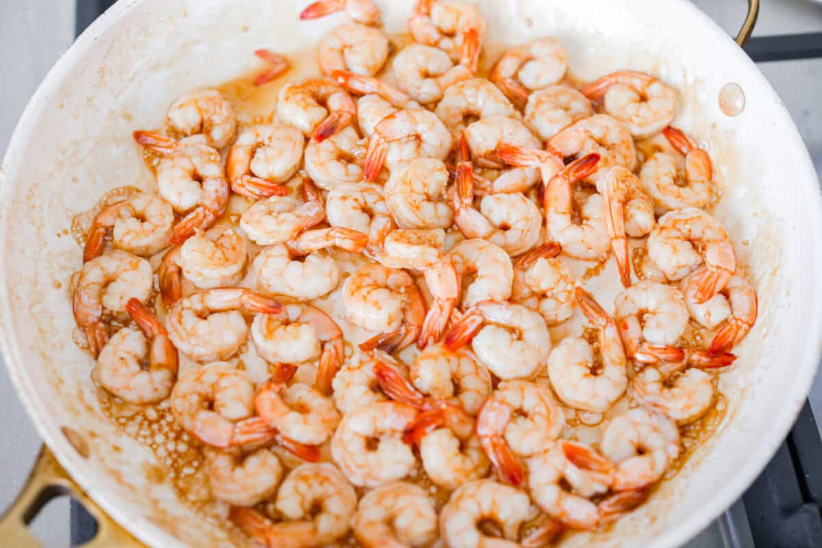 Shrimp cooking in a skillet.