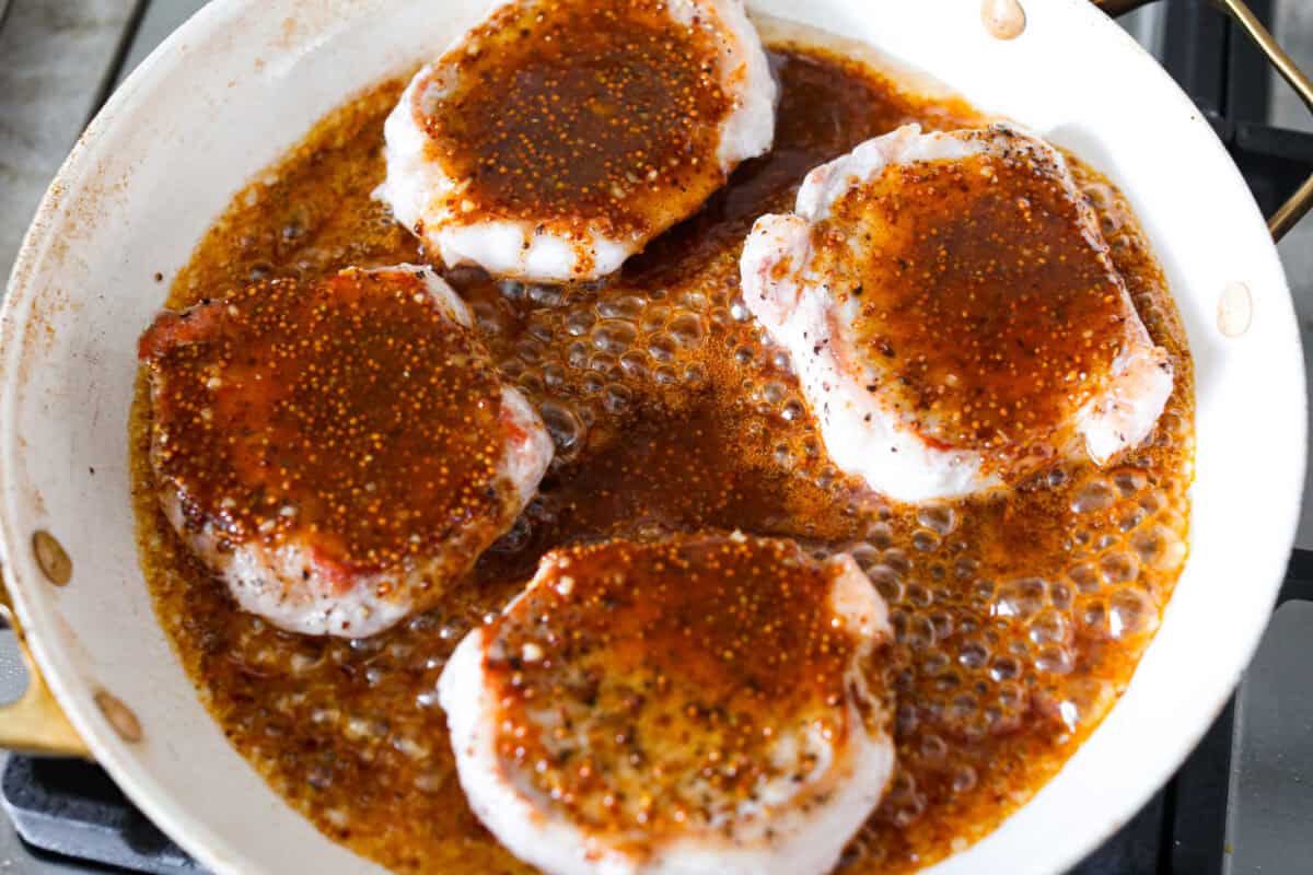 These honey mustard pork chops bring big flavor with very little effort. The whole grain mustard adds texture and bite, while a few extra spices deepen the sauce, turning a simple skillet dinner into something totally crave-worthy. Sauce added to the skillet with the chops.