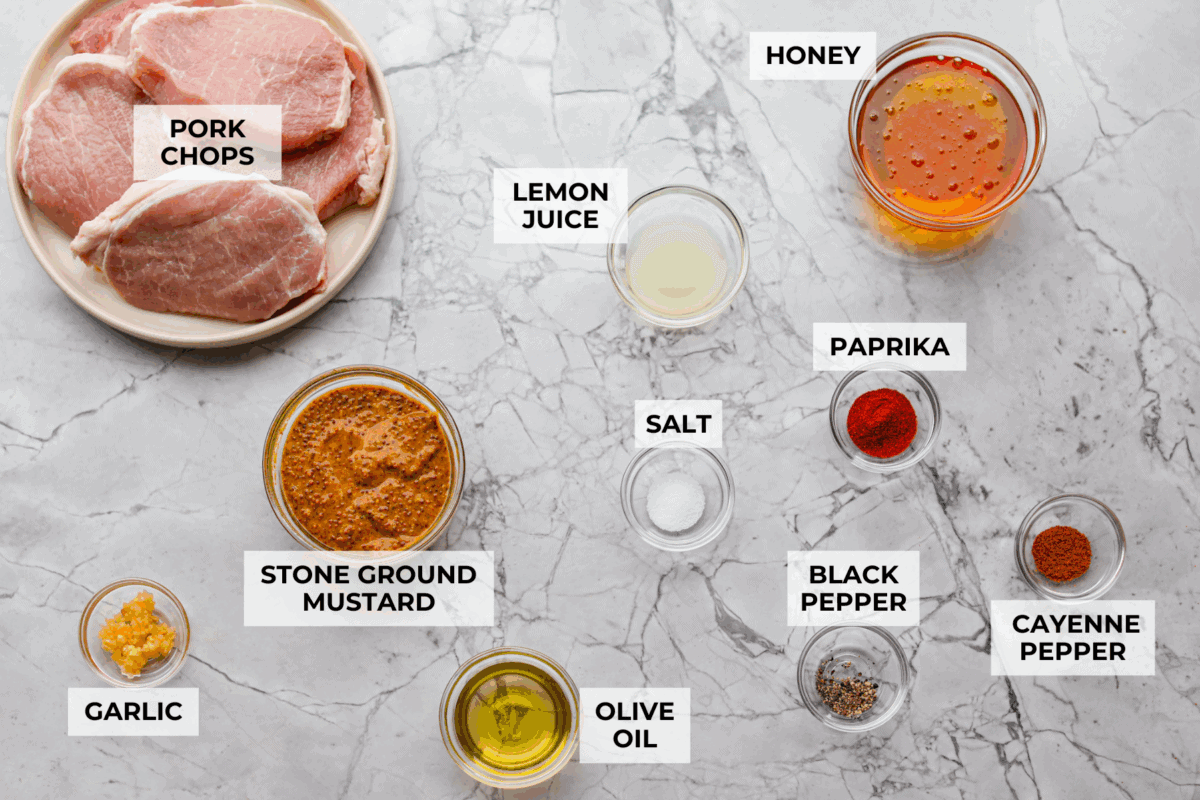 These honey mustard pork chops bring big flavor with very little effort. The whole grain mustard adds texture and bite, while a few extra spices deepen the sauce, turning a simple skillet dinner into something totally crave-worthy. Overhead shot of labeled honey mustard pork chops ingredients.