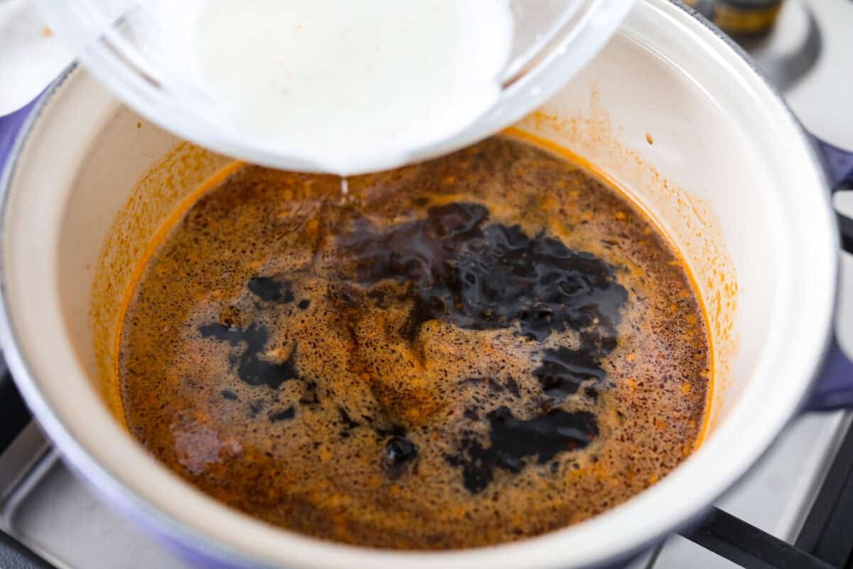 Korean BBQ sauce is the kind of pantry staple that turns random weeknight ingredients into something irresistible. Use it to glaze salmon, coat wings, toss with chicken and veggies, or turn into a killer Korean BBQ pizza Someone pouring in the cornstarch slurry to help thicken the sauce.