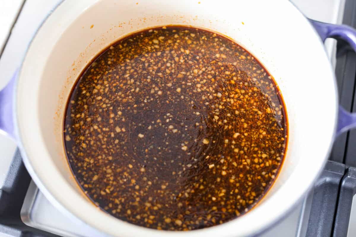 Korean BBQ sauce is the kind of pantry staple that turns random weeknight ingredients into something irresistible. Use it to glaze salmon, coat wings, toss with chicken and veggies, or turn into a killer Korean BBQ pizza All of the sauce ingredients mixed together, simmering in a pot on the stove.