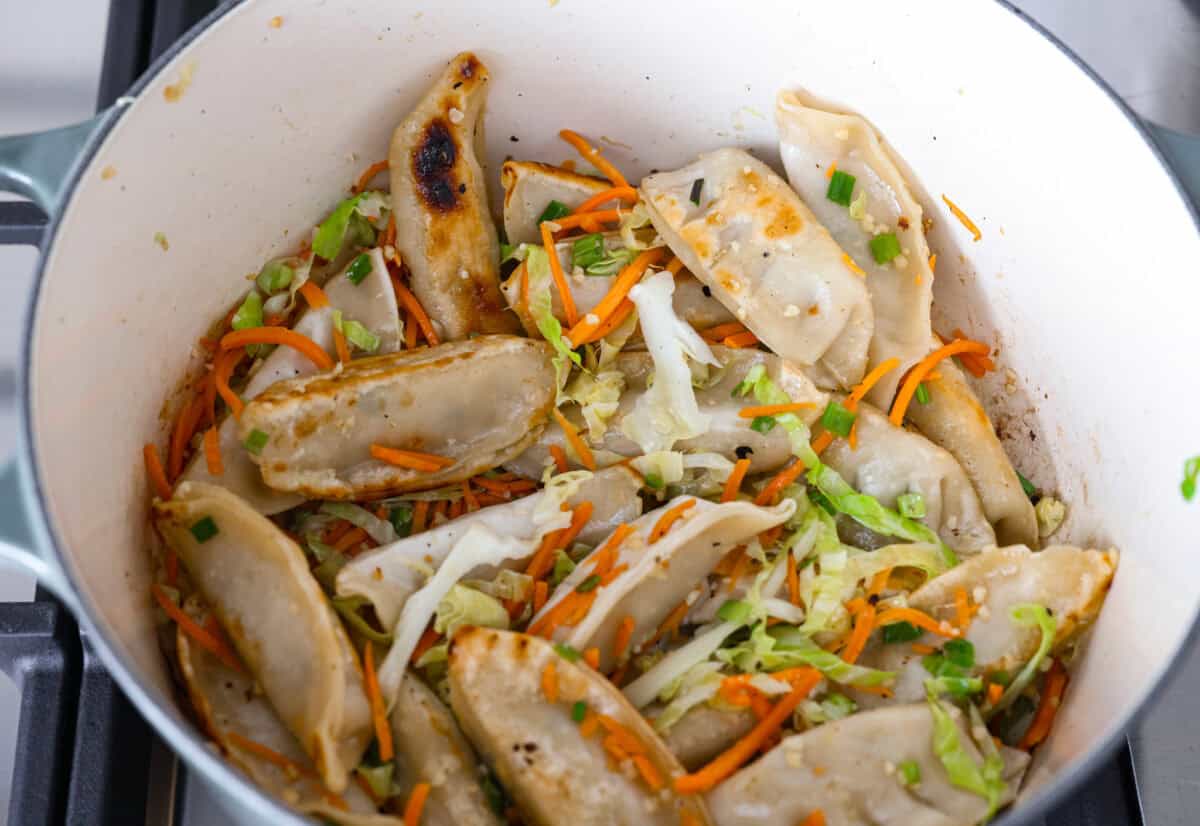 My potsticker soup is what you make when you’re busy, hungry, and need something quick that still tastes really good. All it takes is some frozen potstickers, a simple broth, and a handful of veggies! Veggies added to the potstisckers to cook.