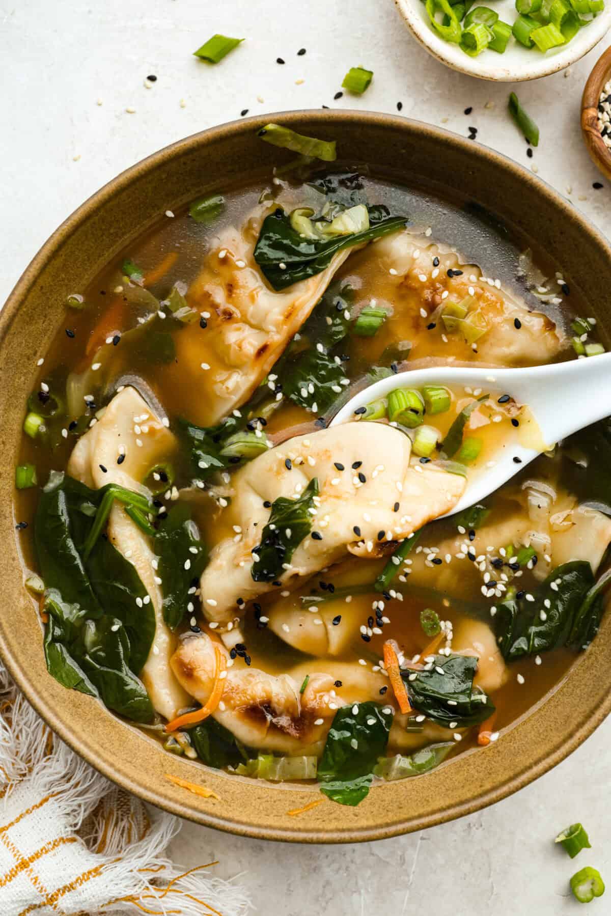 My potsticker soup is what you make when you’re busy, hungry, and need something quick that still tastes really good. All it takes is some frozen potstickers, a simple broth, and a handful of veggies! Bowl of potsticker soup.