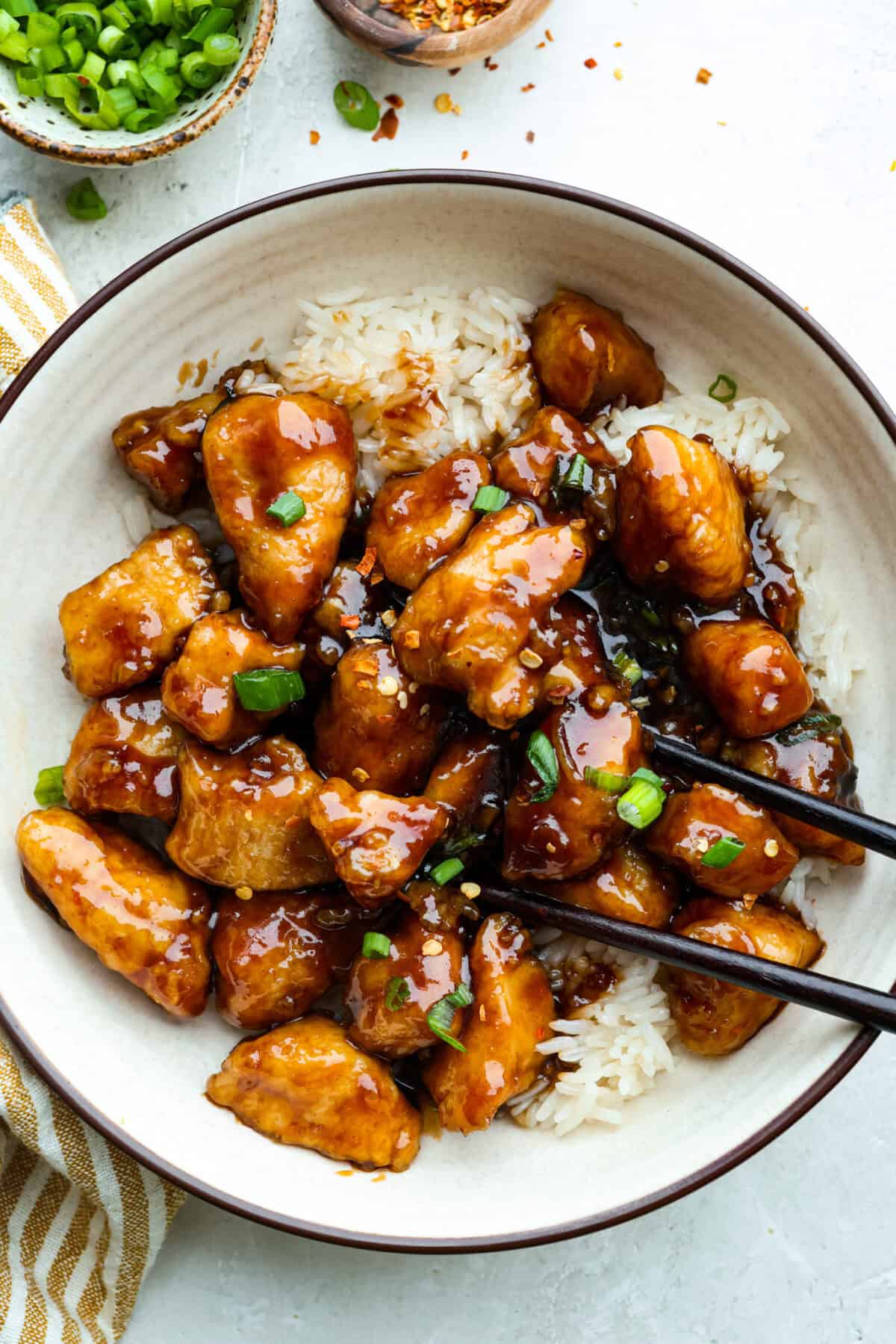 You love my baked General Tso’s chicken, so obviously, I had to make a faster one. This one pan General Tso's chicken is sticky, saucy, and on the table in about 30 minutes. Plate of one pan general Tso's chicken on a bed of rice.