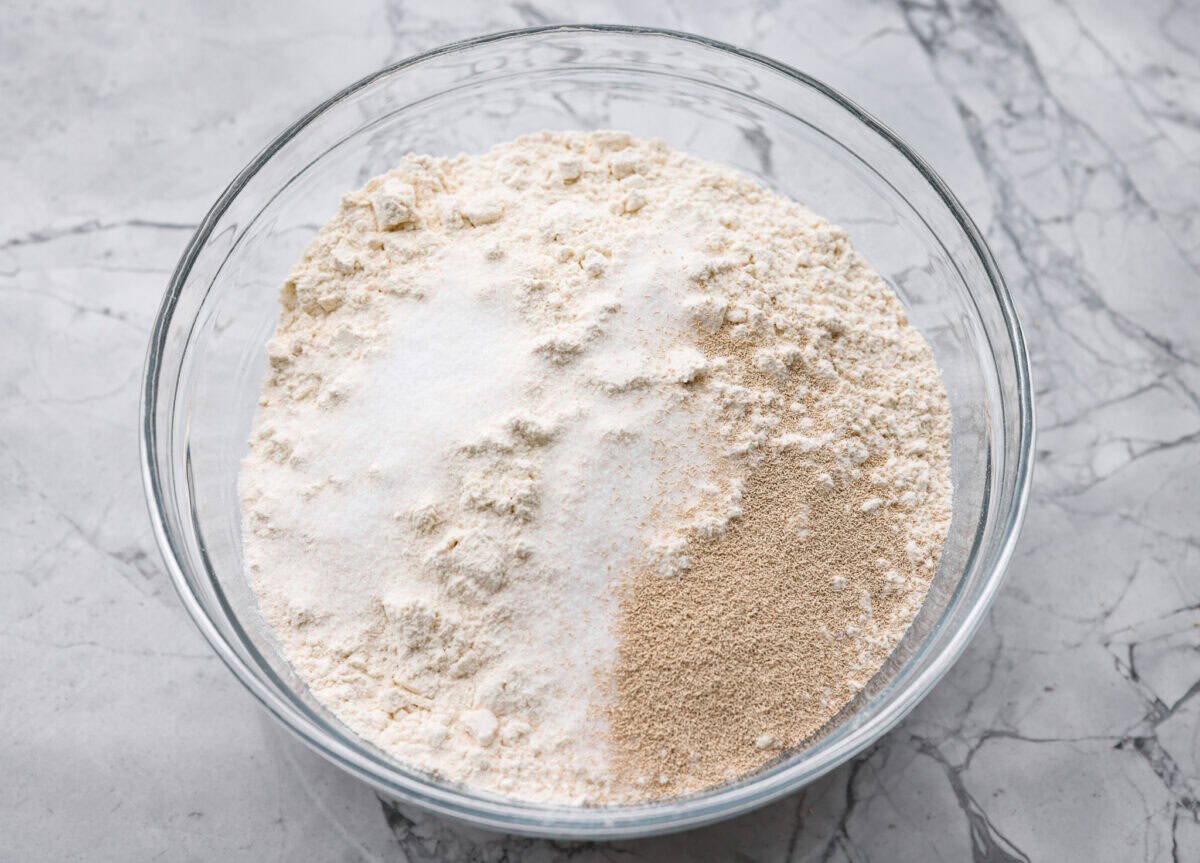 Myย 4-ingredient artisan breadย is simple, rustic, and completely bakery-worthy. With just flour, water, yeast, and salt, youโll get a loaf with a crusty outside and a soft, chewy center. All of the dry ingredients added to a bowl.