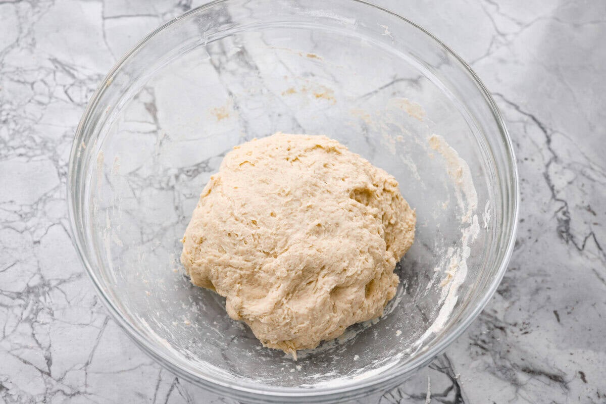 Myย 4-ingredient artisan breadย is simple, rustic, and completely bakery-worthy. With just flour, water, yeast, and salt, youโll get a loaf with a crusty outside and a soft, chewy center. Dough combined and in a ball at the bottom of a bowl.