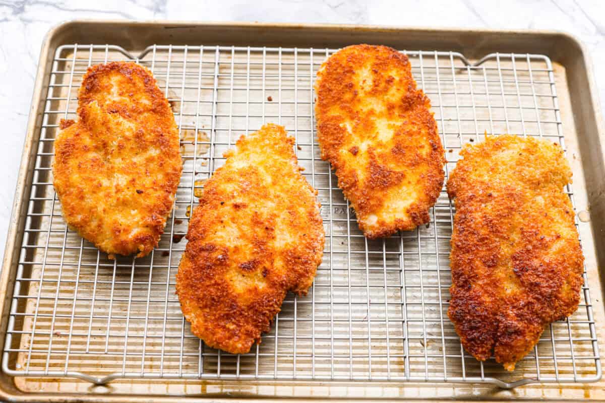 Cooked chicken on a wire rack. 