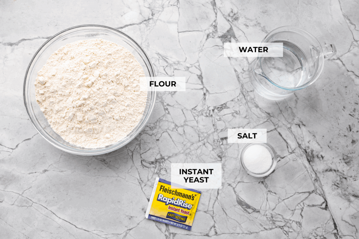 Myย 4-ingredient artisan breadย is simple, rustic, and completely bakery-worthy. With just flour, water, yeast, and salt, youโll get a crusty loaf with a soft, chewy center, no fuss required. Overhead shot of labeled artisan bread ingredients.