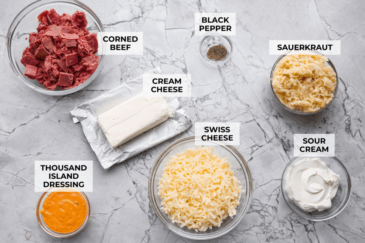 Overhead shot of labeled hot reuben dip ingredients. 