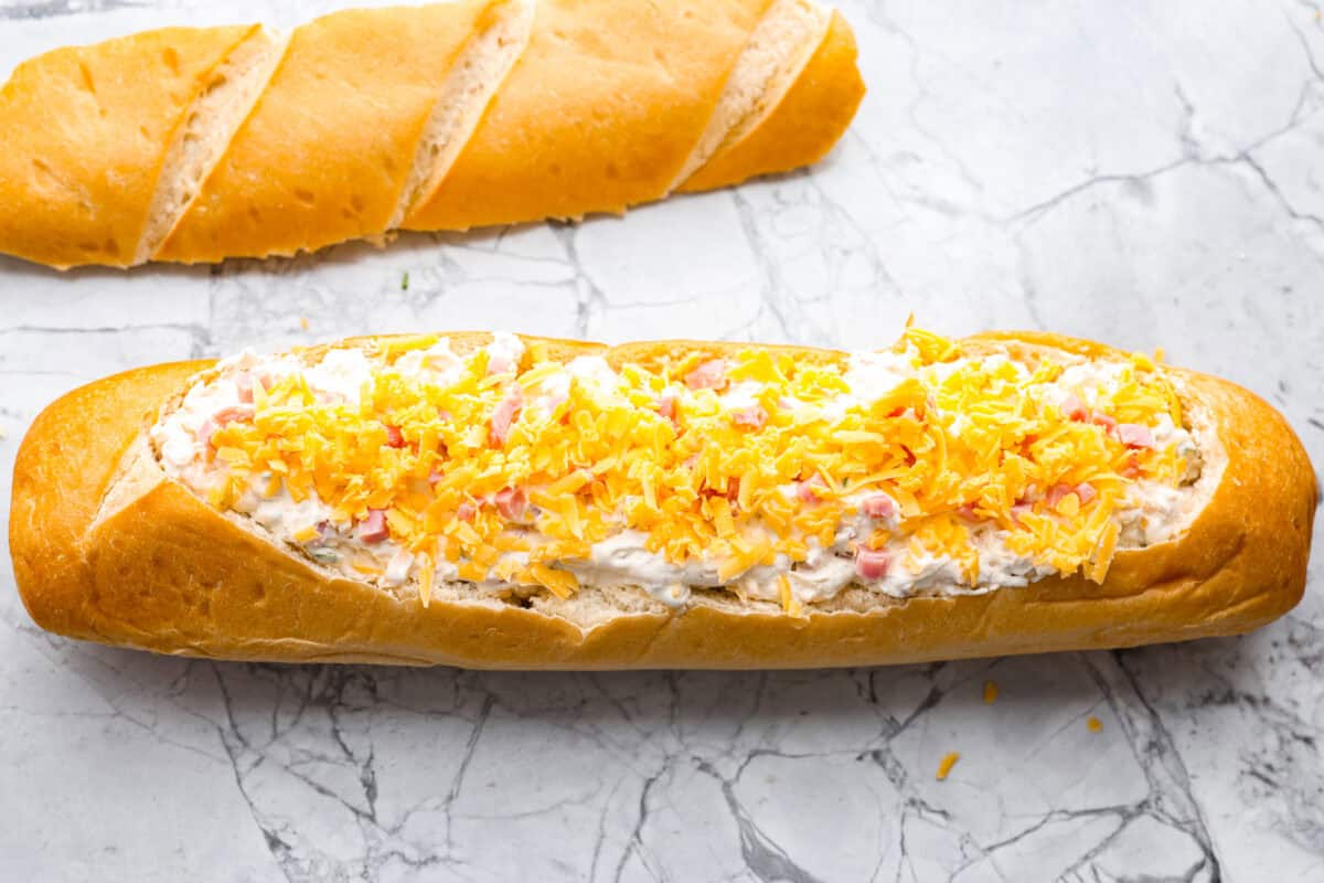Dip added to the loaf of french bread and then topped with cheese. 