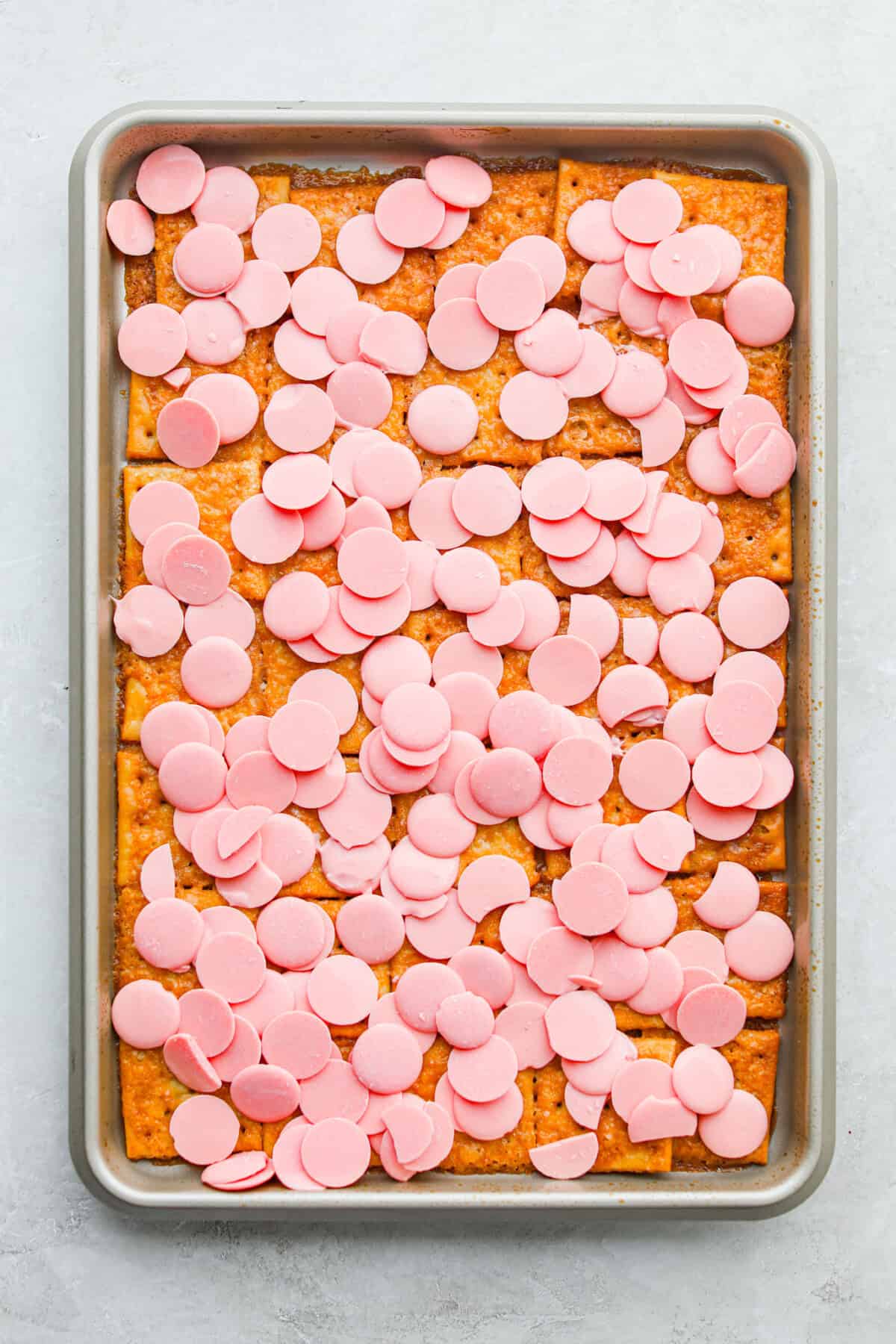 My Valentine’s Day Crack is the cutesy pink version of my famous Christmas crack! Same buttery, snappy toffee base, just with pink candy melts and festive sprinkles. It's perfect for kids' parties, Galentine's, or a sweet little Valentine's treat. Toffee spread over the saltines and baked then the mink candy melts added to the top to melt.