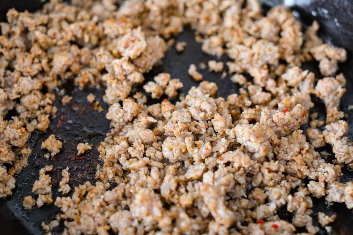 If you love a creamy pasta with big flavor, this creamy sausage spaghetti needs to be on your menu. Smoked Gouda adds depth, the sausage brings a little heat, and fresh basil adds brightness. Simple ingredients, quick to make, and always a hit! Sausage browning in the skillet.