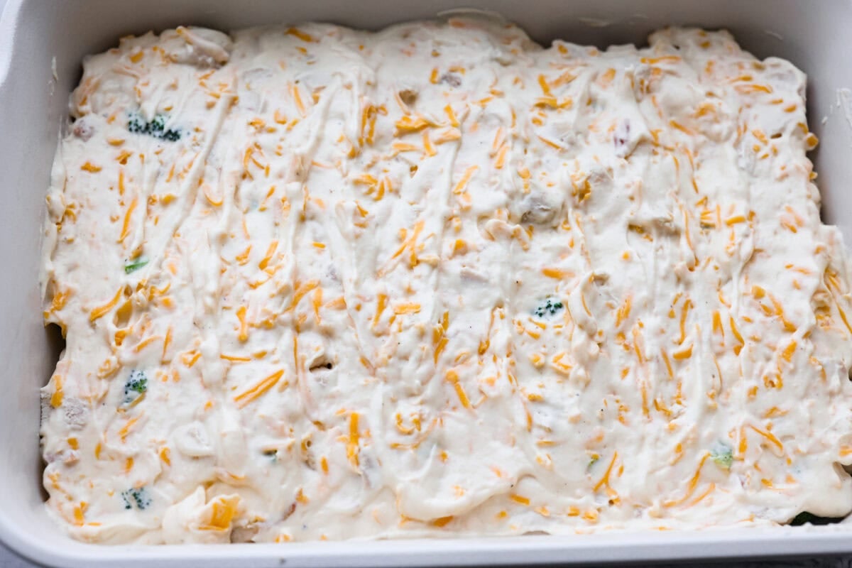 Chicken Divan is what I make when I want comfort food that still feels a little put-together. You get tender chicken, crisp-tender broccoli, and a creamy sauce bubbling under the most delicious golden, crunchy topping! Sauce spread out of the broccoli and chicken.