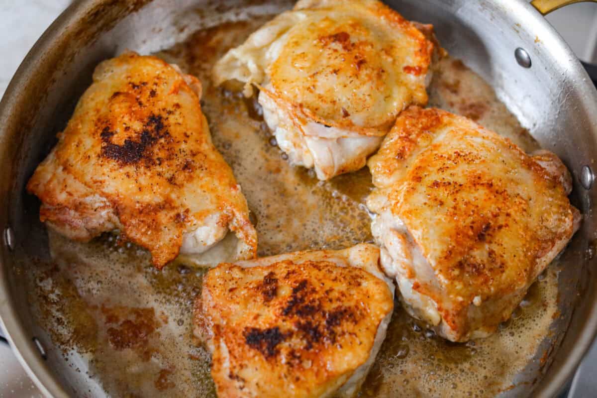 Chicken cooking in the bacon grease. 