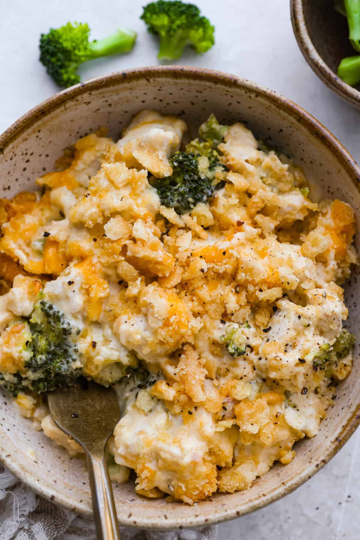 Chicken Divan is what I make when I want comfort food that still feels a little put-together. You get tender chicken, crisp-tender broccoli, and a creamy sauce bubbling under the most delicious golden, crunchy topping! Bowl of a serving portion chicken divan casserole.