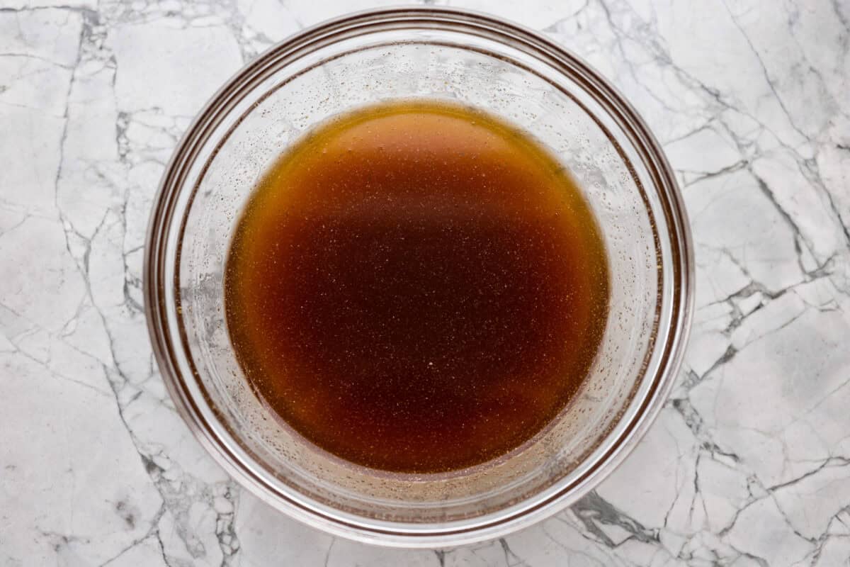 Skip takeout and make this PF Chang’s honey chicken in your own kitchen! Crispy fried chicken gets coated in a glossy honey sauce that’s sweet, savory, and hard to resist Bowl of sauce ingredients whisked together.