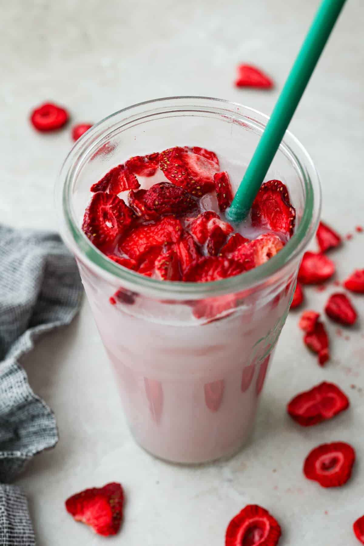 You guys, Starbucks sells the Strawberry Açaí concentrate in stores! Which means we can make the famous Starbuck's Pink Drink at home! And let me tell you, it's spot on! With just three ingredients, it's ridiculously easy to make year-round, and so good! Top angle shot of the Starbucks copycat pink drink.