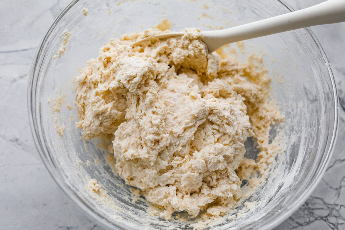 These cinnamon roll butter swim biscuits are my cheat code to making "cinnamon rolls." They bake up soft and fluffy with a sweet cinnamon swirl and icing on top. They disappear almost as fast as you can make them! Buttermilk added to the dry ingredients and mixed together.