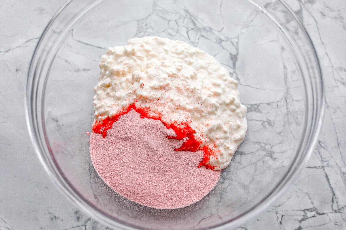 Cottage cheese and Jello packet dumped in a large bowl. 