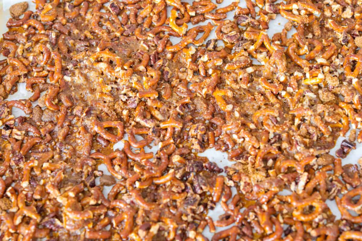 The cracked pretzel mixture is cooked and set on a cookie sheet. 