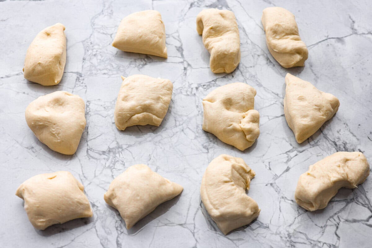 If warm, homemade bread is your weakness, you’re going to love these French bread rolls. They’re soft, chewy, and perfect for everything from weeknight dinners to holiday meals. Pieces of dough cut into sections.