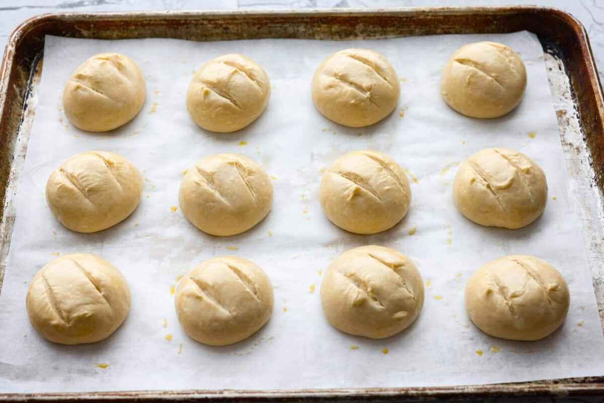 If warm, homemade bread is your weakness, you’re going to love these French bread rolls. They’re soft, chewy, and perfect for everything from weeknight dinners to holiday meals. French bread dough balls scoured and covered in an egg wash, ready to go in the oven.